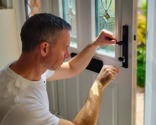 Locksmith fitting lock to front door